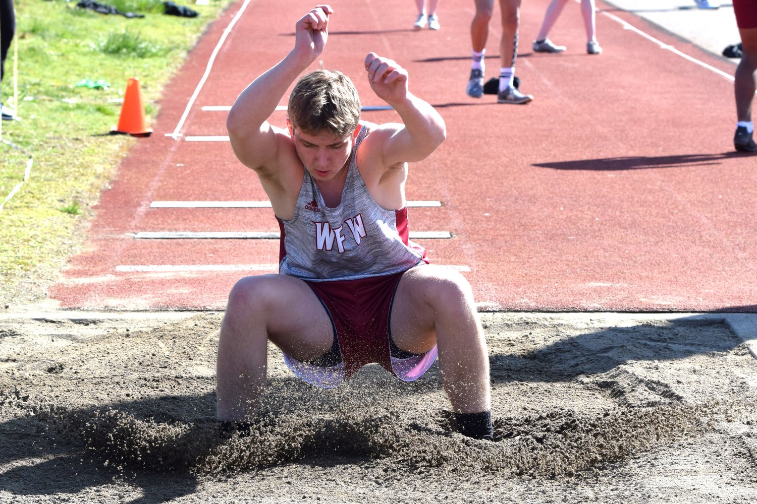 Bradley Blankenship lands in the pit at the Cardinal Relays, March 18 in Orting.